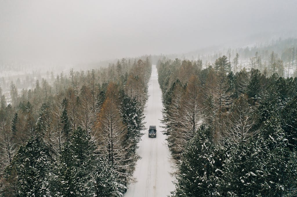 SUV Driving on Snow Covered Road